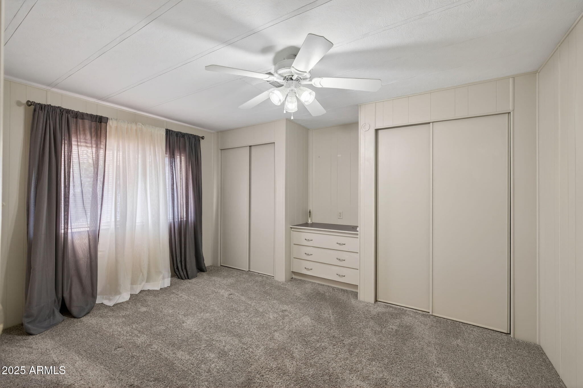 201 South Greenfield Road, Unit 310 Mesa, AZ 85206 - Photo 16 of 34 an empty room with closet and windows