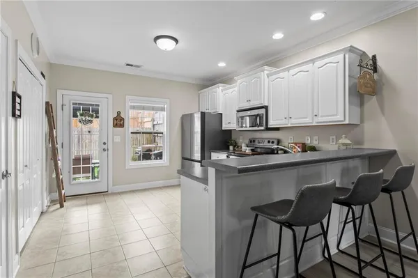 a kitchen with stainless steel appliances granite countertop a refrigerator and microwave