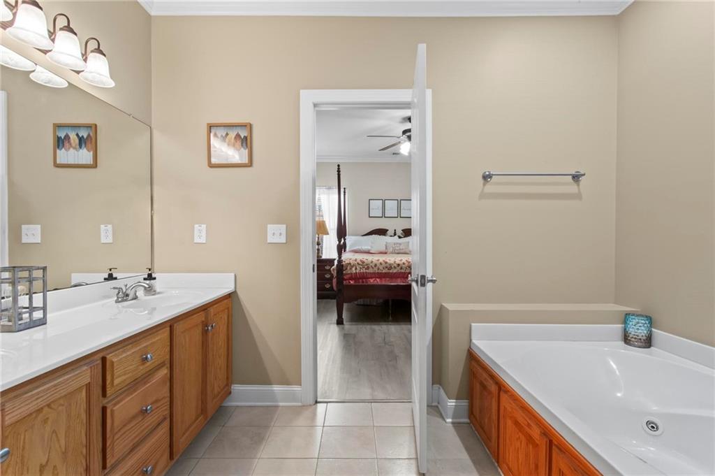 534 Hamilton Way, Unit 3 Chatsworth, GA 30705 - Photo 14 of 22 a en suite bathroom with a tub sink and mirror