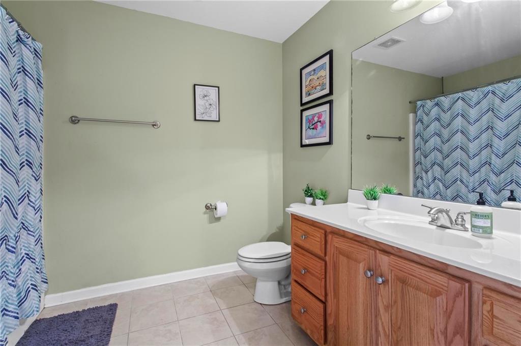 534 Hamilton Way, Unit 3 Chatsworth, GA 30705 - Photo 17 of 22 a bathroom with a granite countertop sink mirror vanity and toilet