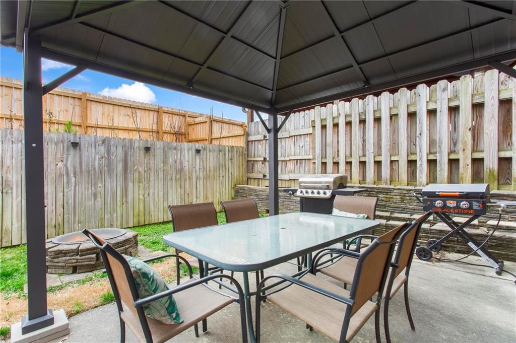 534 Hamilton Way, Unit 3 Chatsworth, GA 30705 - Photo 21 of 22 a view of a patio with table and chairs under an umbrella