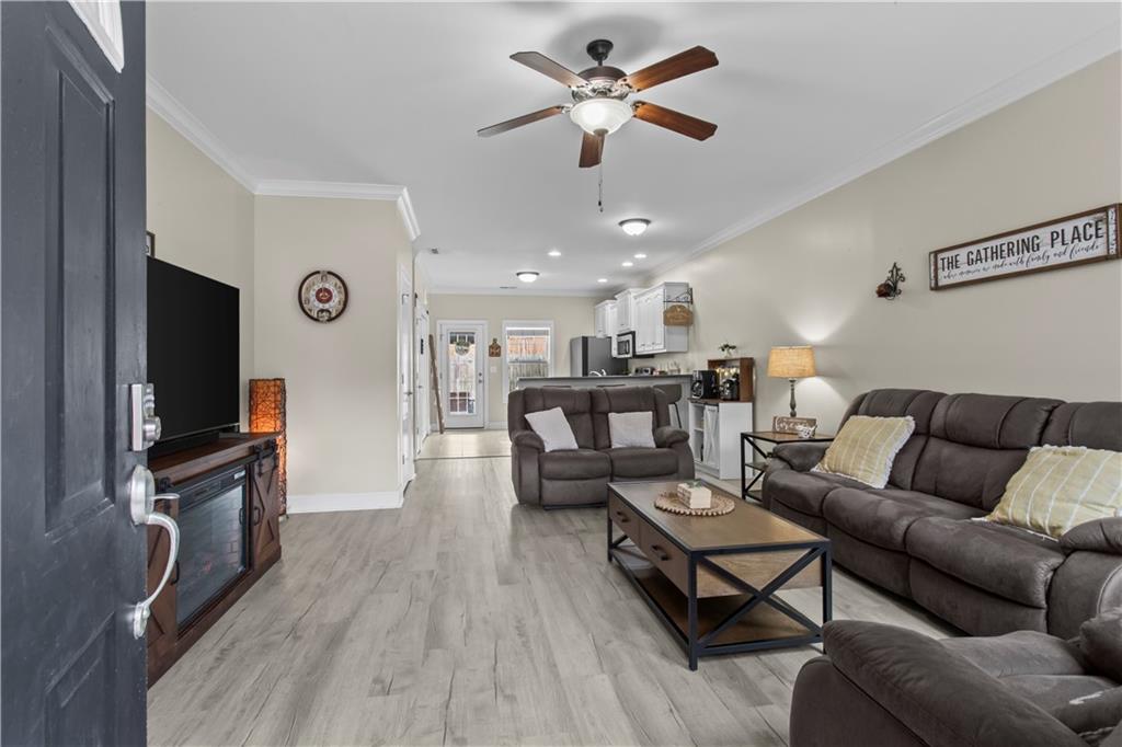 534 Hamilton Way, Unit 3 Chatsworth, GA 30705 - Photo 4 of 22 a living room with furniture a ceiling fan and a flat screen tv