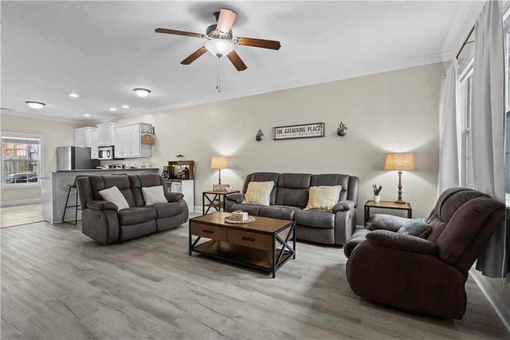 534 Hamilton Way, Unit 3 Chatsworth, GA 30705 - Photo 5 of 22 a living room with furniture kitchen view and a chandelier