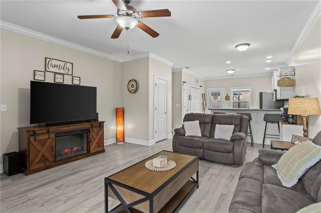 534 Hamilton Way, Unit 3 Chatsworth, GA 30705 - Photo 6 of 22 a living room with furniture a flat screen tv and a fireplace