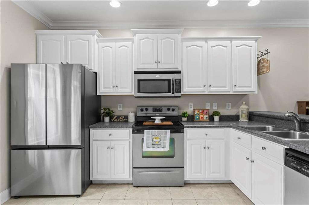 534 Hamilton Way, Unit 3 Chatsworth, GA 30705 - Photo 8 of 22 a kitchen with stainless steel appliances granite countertop white cabinets and a refrigerator