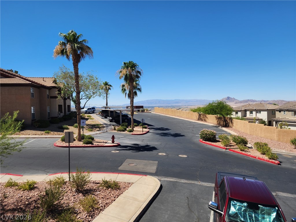231 West Horizon Ridge Parkway, Unit 1127 Henderson, NV 89012 - Photo 29 of 39 An inviting community layout with well-maintained grounds, offering a serene desert landscape view.