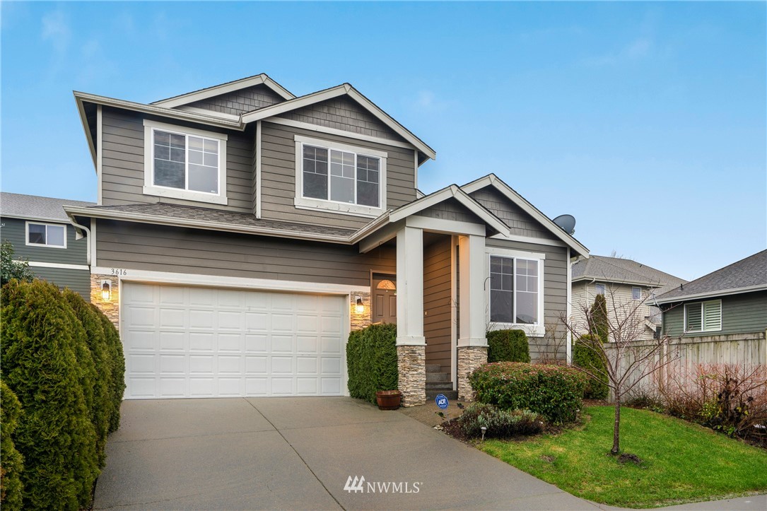 3616 Mill Place South Renton, WA 98055 - Photo 2 of 25 a front view of a house with a yard and garage