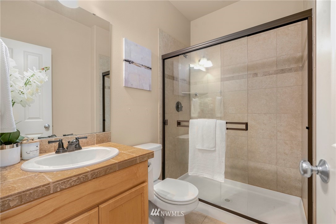 3616 Mill Place South Renton, WA 98055 - Photo 12 of 25 a bathroom with a granite countertop sink toilet and shower