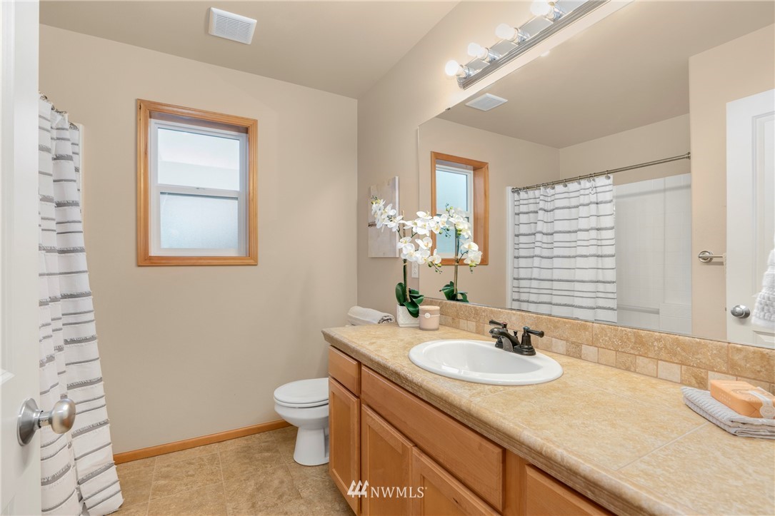 3616 Mill Place South Renton, WA 98055 - Photo 17 of 25 a bathroom with a granite countertop sink toilet and mirror