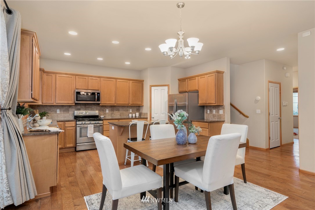3616 Mill Place South Renton, WA 98055 - Photo 6 of 25 a view of a dining room with furniture wooden floor and chandelier