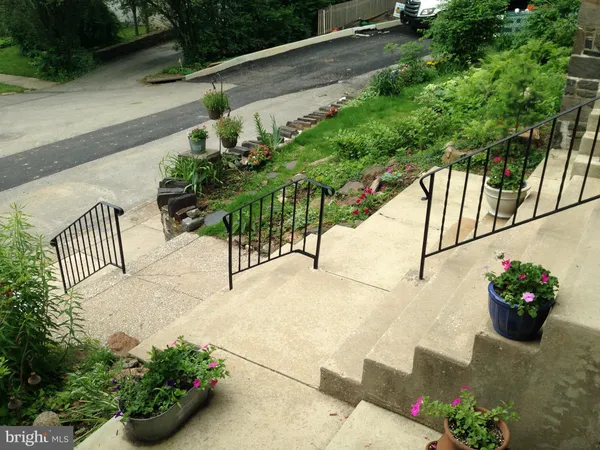 a kitchen with stainless steel appliances wooden floor and a refrigerator