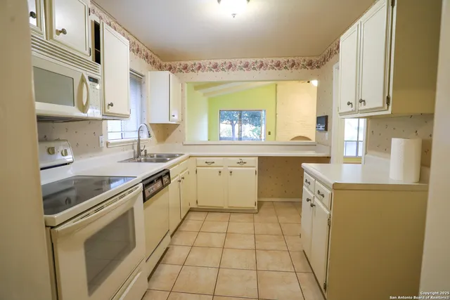 a kitchen with a stove a sink and a refrigerator