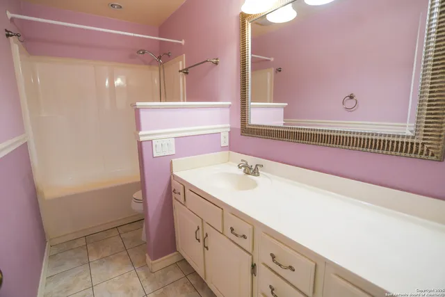 a bathroom with a sink a vanity and a mirror