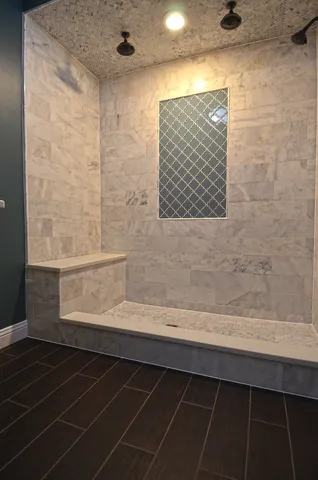 a bathroom with a bathtub and a shower