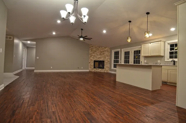 a view of kitchen with granite countertop cabinets stainless steel appliances and wooden floor