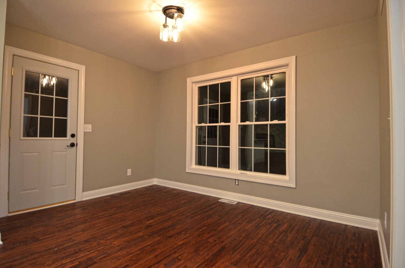 3290 East 289th Road LaSalle, IL 61301 - Photo 8 of 23 a view of an empty room with wooden floor and windows