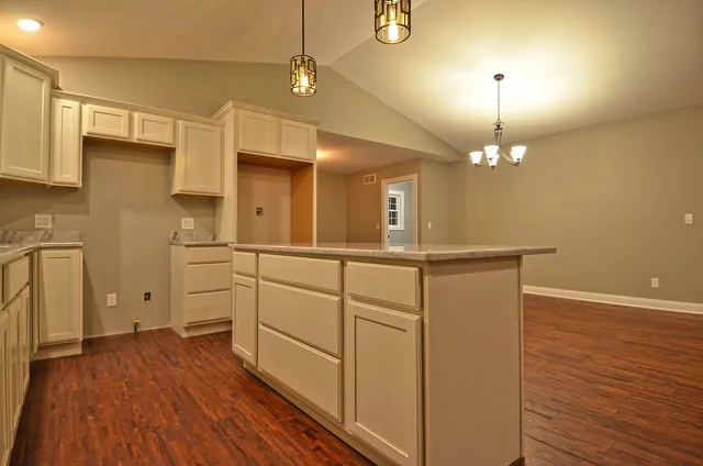a view of a kitchen with a sink wooden floor and staircase