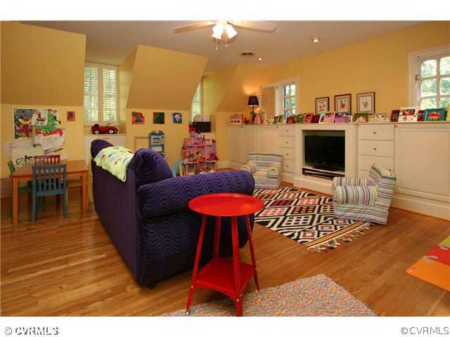 8401 River Road Richmond, VA 23229 - Photo 19 of 25 a living room with furniture a flat screen tv and a fireplace