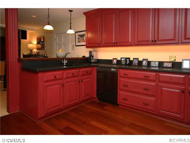 8401 River Road Richmond, VA 23229 - Photo 22 of 25 a kitchen with granite countertop wooden cabinets