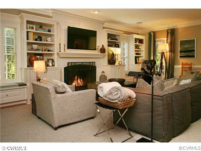 8401 River Road Richmond, VA 23229 - Photo 7 of 25 a living room with furniture a flat screen tv and a fireplace