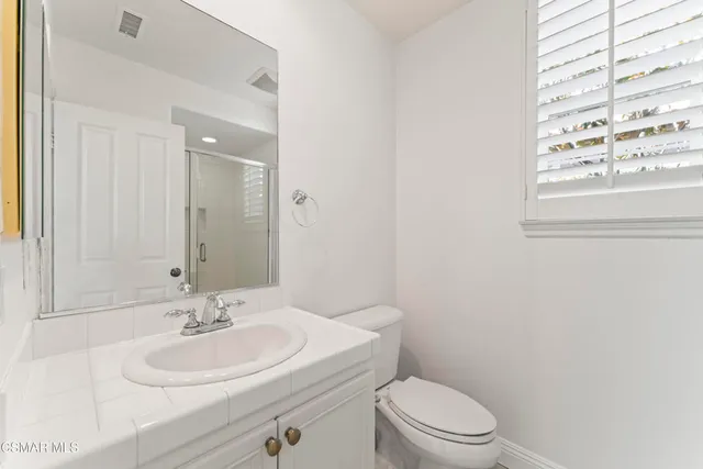 a bathroom with a sink toilet and mirror