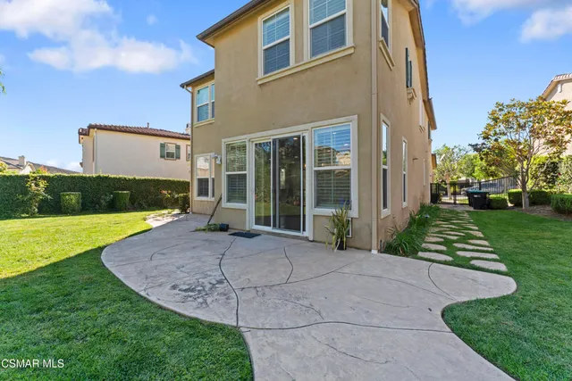 a view of a house with backyard porch and garden