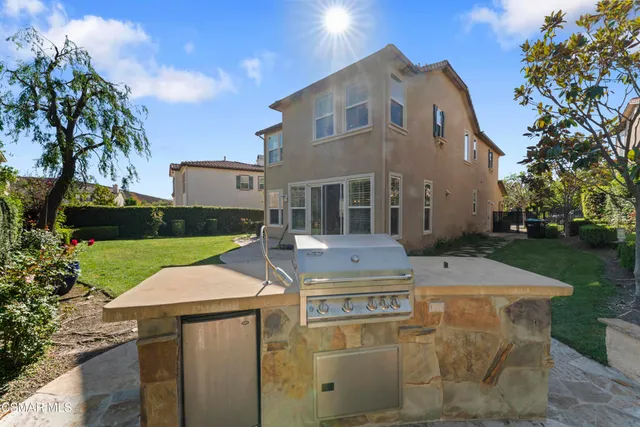 a aerial view of a house with table and chairs under an umbrella