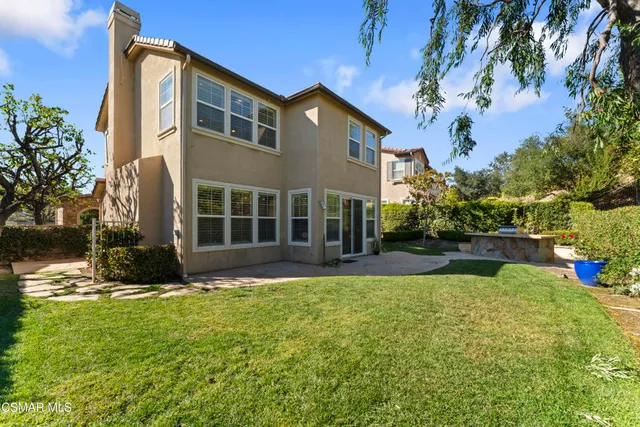 a view of a house with a yard and plants