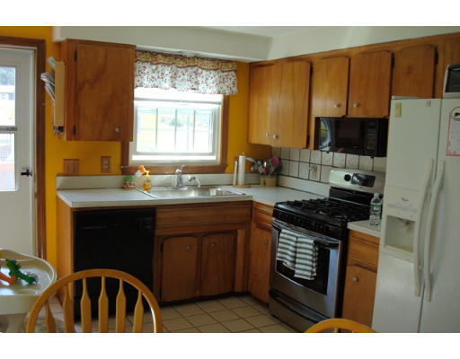 31 Cambridge Road Nashua, NH 03062 - Photo 2 of 11 a kitchen with a sink stove top oven and cabinets