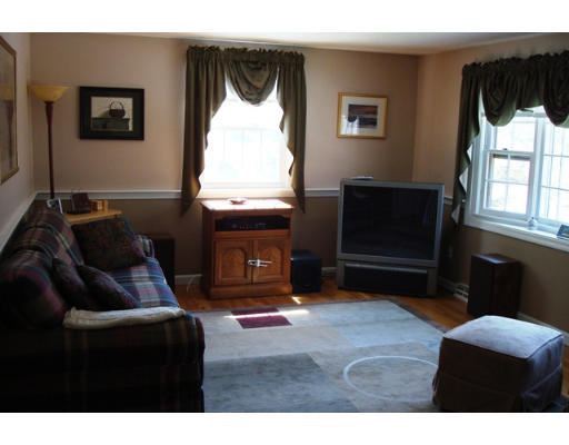 31 Cambridge Road Nashua, NH 03062 - Photo 4 of 11 a living room with furniture a window and a fireplace