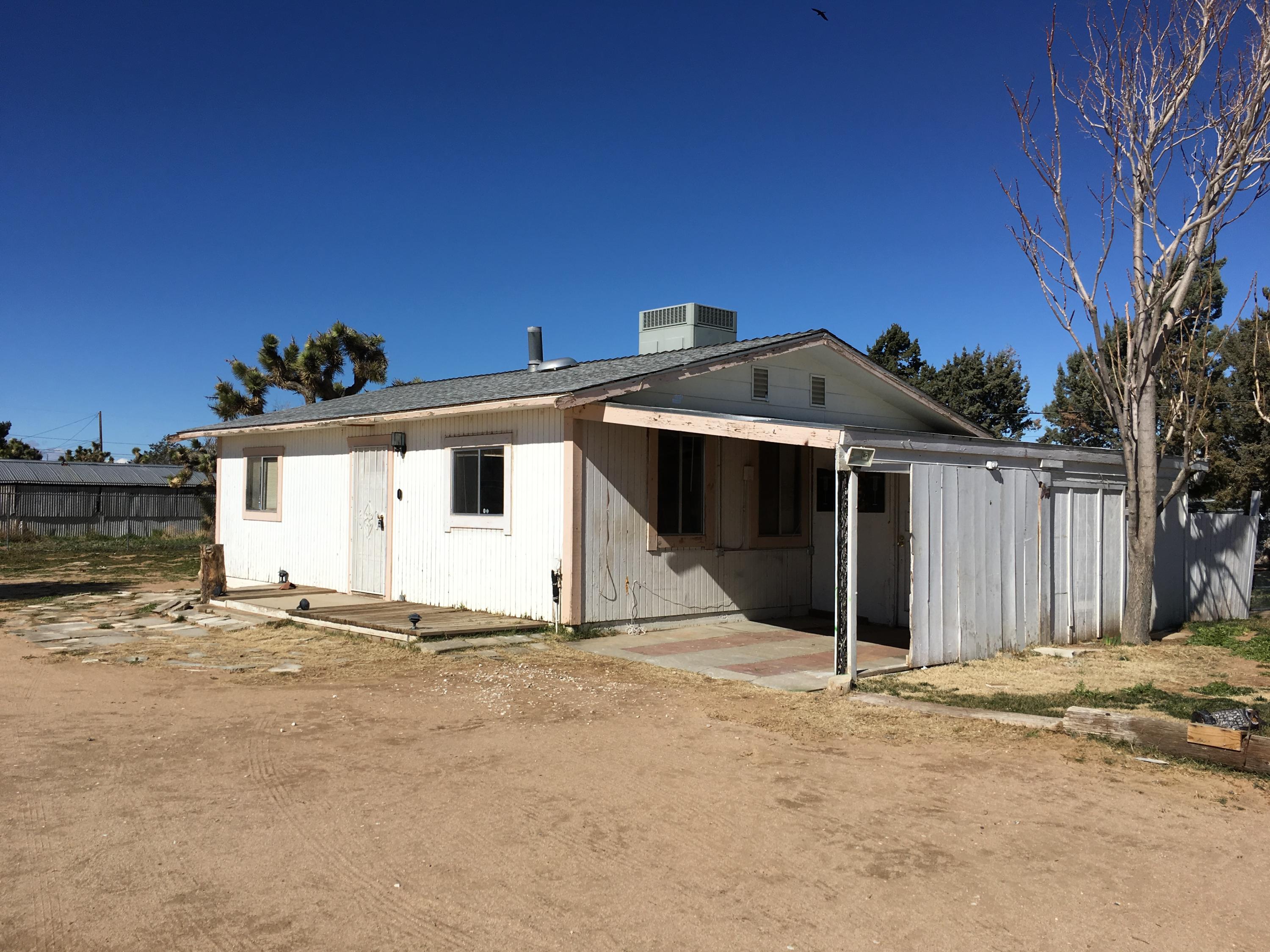 43254 52nd Street West Lancaster, CA 93536 - Photo 13 of 18 a front view of a house with a yard
