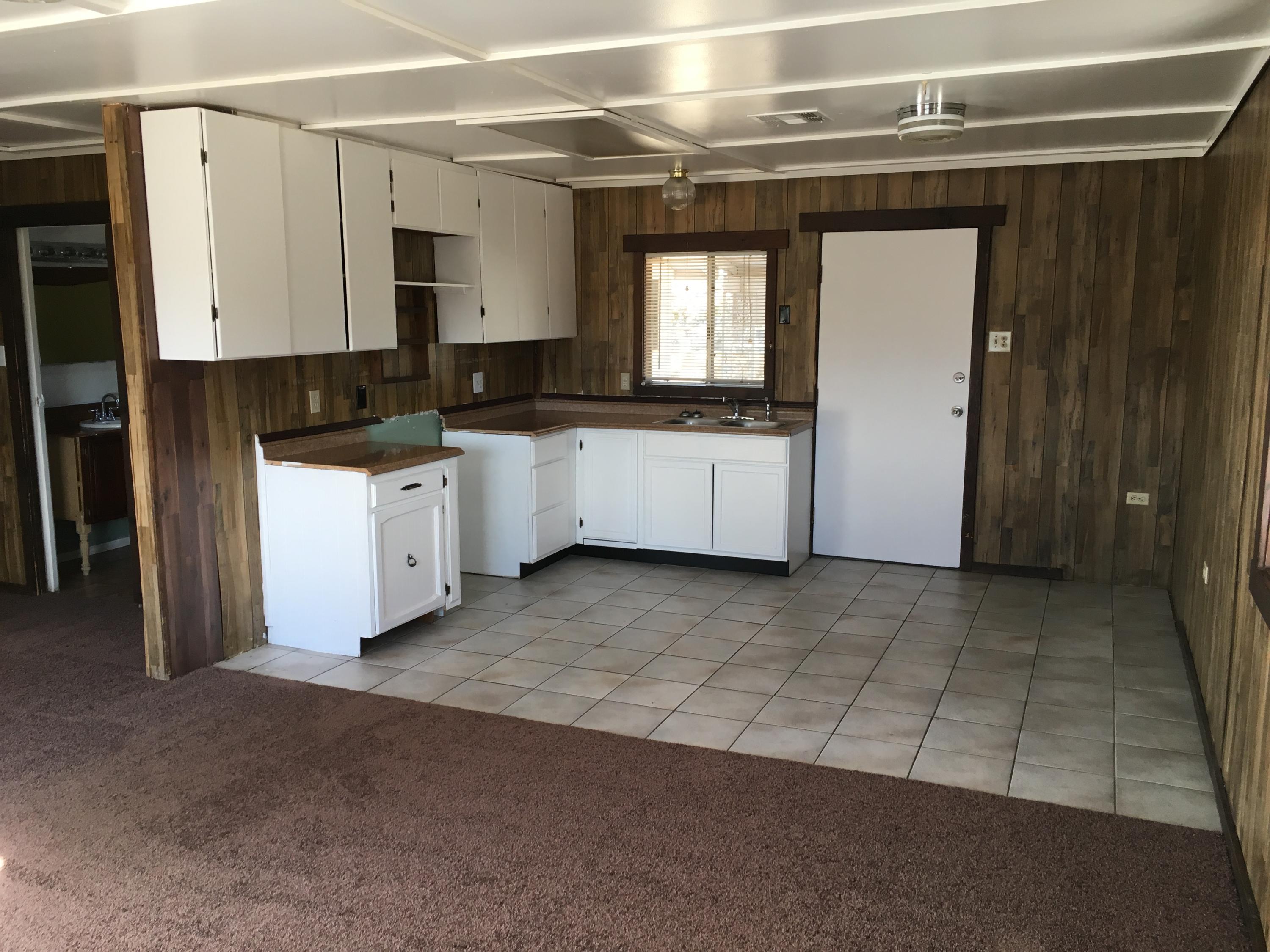 43254 52nd Street West Lancaster, CA 93536 - Photo 14 of 18 a kitchen with stainless steel appliances a sink stove and cabinets