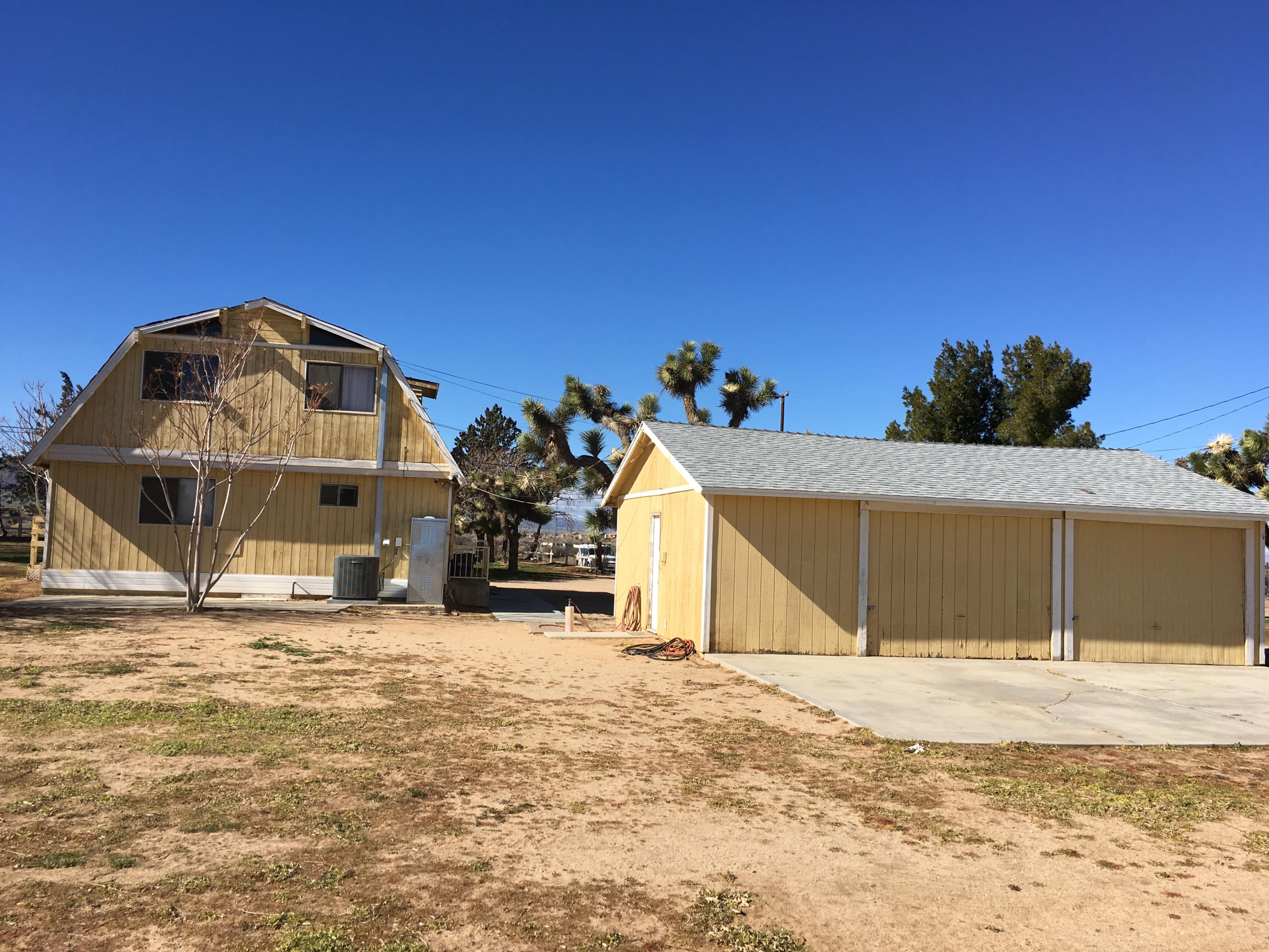43254 52nd Street West Lancaster, CA 93536 - Photo 2 of 18 a front view of a house with a yard