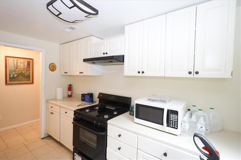 236 Hiram Sudie Road Dallas, GA 30157 - Photo 21 of 26 a kitchen with stainless steel appliances a white stove top oven and cabinets