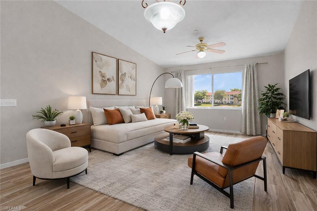 a living room with furniture a flat screen tv and a large window