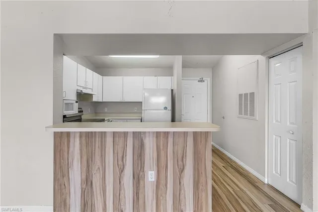 a kitchen with stainless steel appliances a sink and cabinets