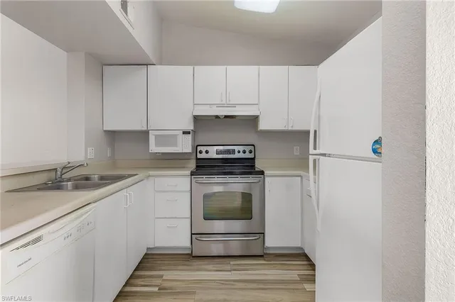 a kitchen with a stove and a refrigerator