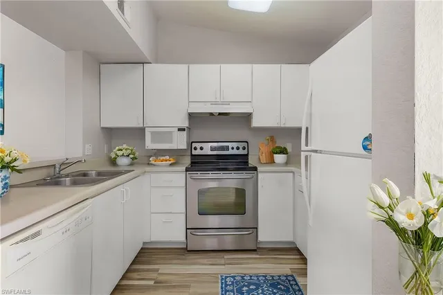 a kitchen with a refrigerator and a sink