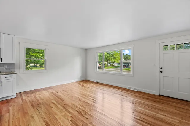wooden floor in an empty room with a window