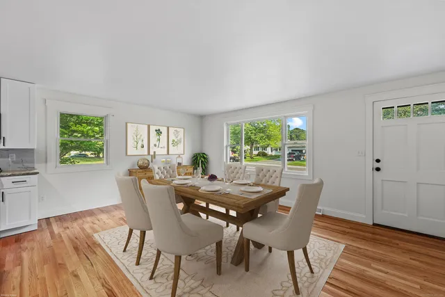 a view of a dining room with furniture and windows