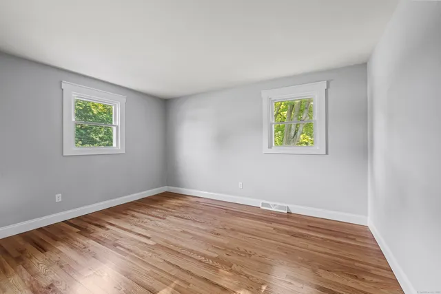 a view of room with window and wooden floor