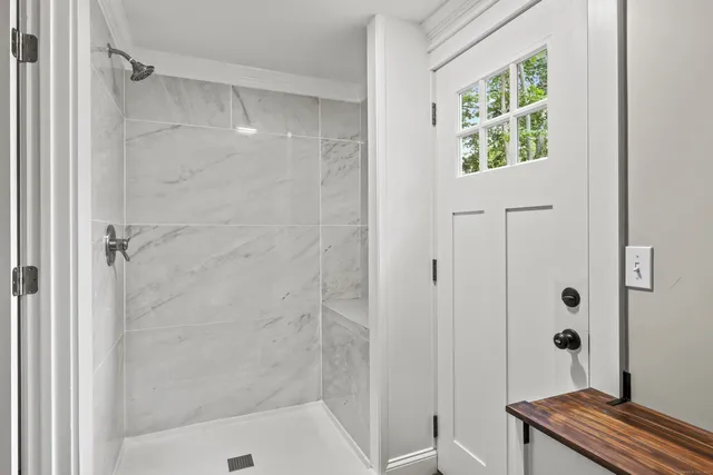 a bathroom with a bathtub and shower