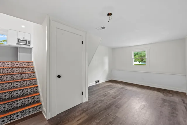 wooden floor in an empty room with a window
