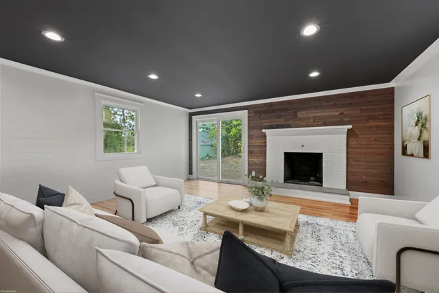 a living room with furniture fireplace and window