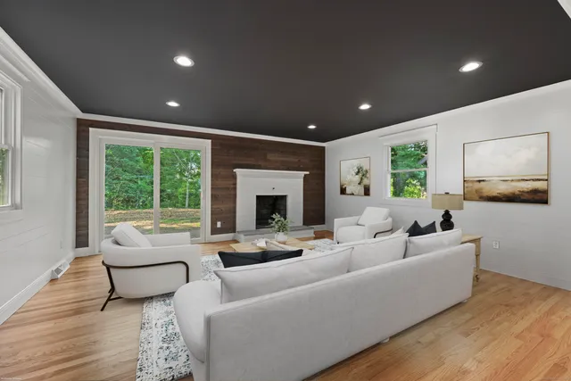 a living room with furniture and a fireplace