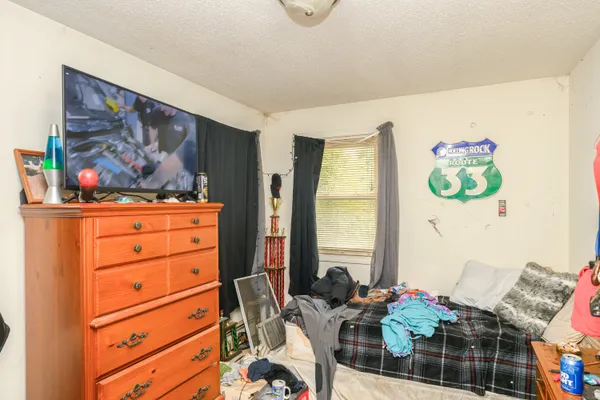 a bedroom with furniture and a window