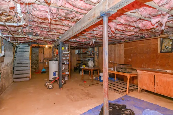 a view of a room with wooden floor and chairs
