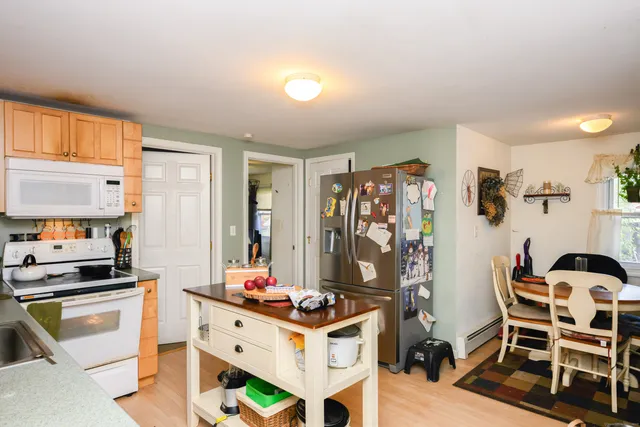 a kitchen with stainless steel appliances kitchen island granite countertop a stove and a refrigerator