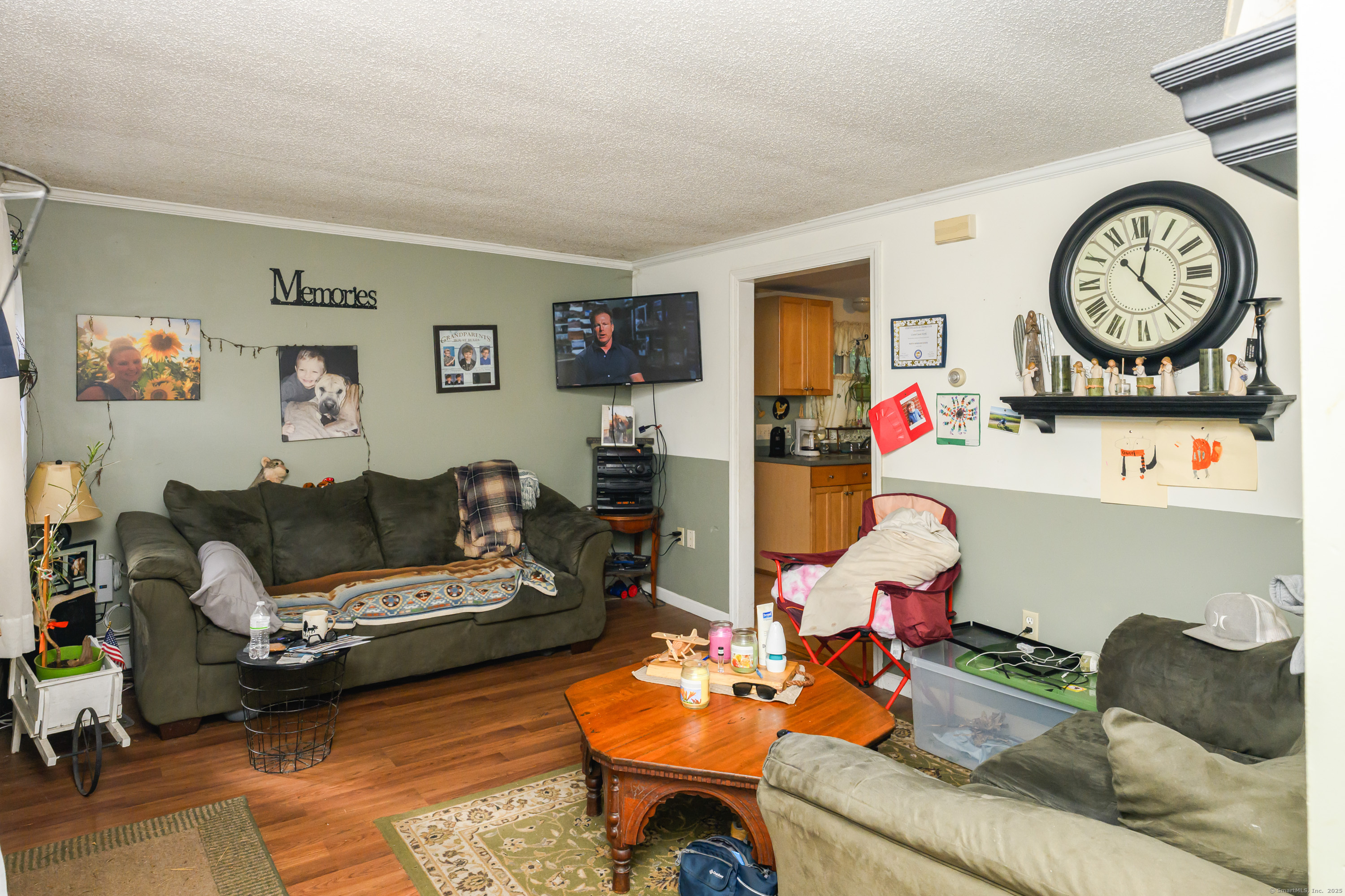 80 Old Plains Road Windham, CT 06226 - Photo 6 of 19 a living room with furniture a clock on wall and a table