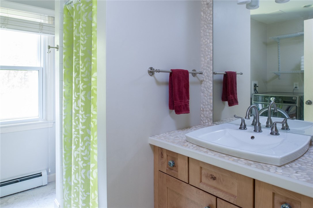 2097 Middle Road East Greenwich, RI 02818 - Photo 15 of 29 The first floor full bathroom/laundry area offers a shower, ceramic flooring, an updated vanity and storage.